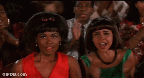 Two Women Standing In Crowd Applauding GIF