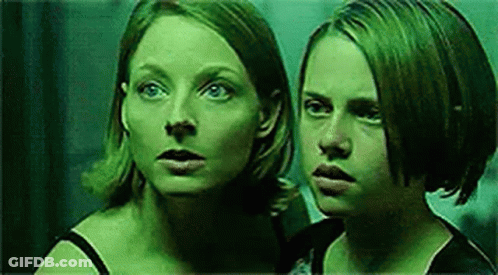Two Women Standing In Dark Room GIF