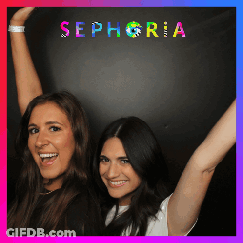Two Women Standing In Front Of A Sign That Says Sephora GIF