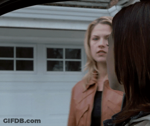 Two Women Standing In Front Of Garage GIF
