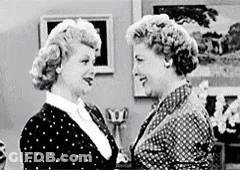 Two Women Standing In Living Room Looking At Each Other GIF