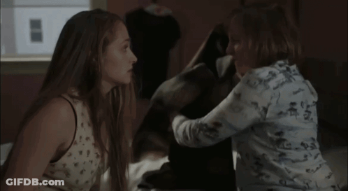 Two Women Standing In Room Looking At Each Other GIF