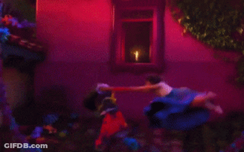 Two Women Standing Next To Candle GIF