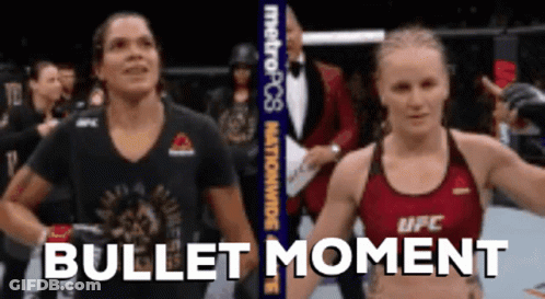 Two Women Standing Next To Each Other Bullet Moment GIF