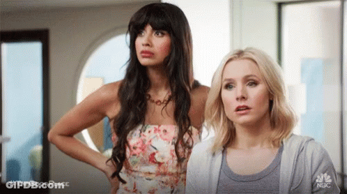 Two Women Standing Next To Each Other GIF