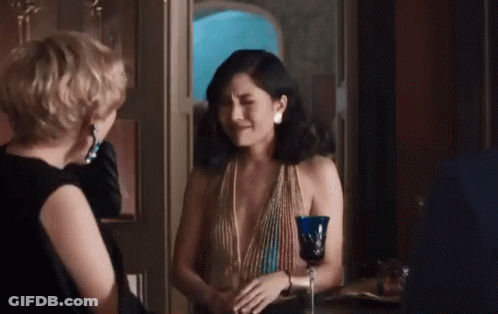 Two Women Standing Next To Each Other GIF