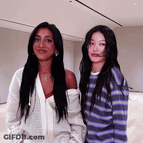 Two Women Standing Next To Each Other GIF