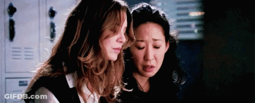 Two Women Standing Next To Each Other In Room With Lockers GIF