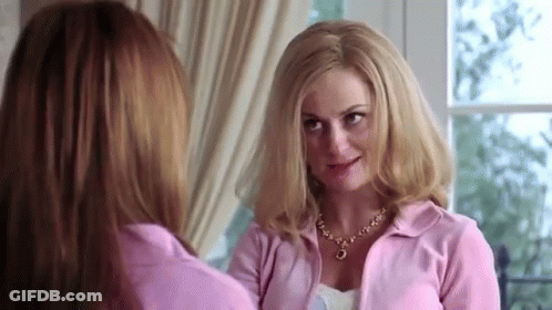 Two Women Standing Next To Each Other Looking GIF