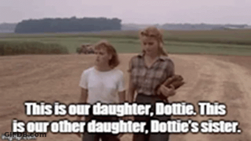 Two Women Standing Next To Each Other GIF