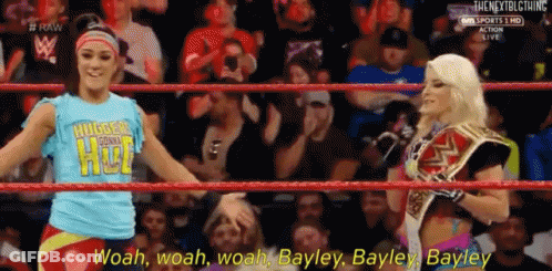 Two Women Standing Next To Each Other One Holding Championship Belt GIF