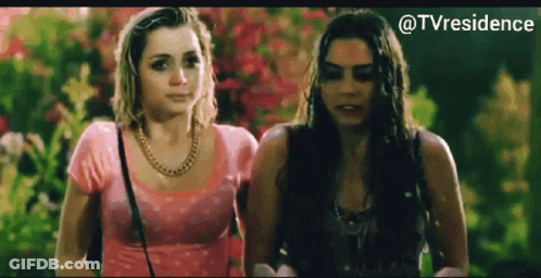 Two Women Standing Next To Each Other GIF