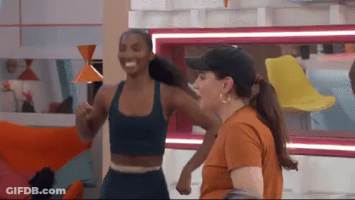 Two Women Standing Next To Each Other Smiling GIF