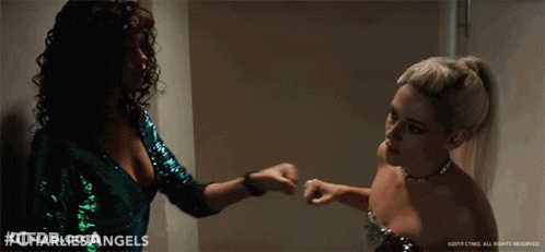 Two Women Standing Next To Each Other GIF