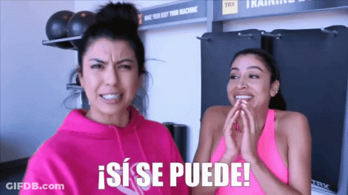 Two Women Standing Next To Each Other With A Sign That Says Trx In The Background GIF
