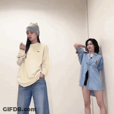 Two Women Standing Next To Each Other With One Wearing A Sweater With A Lacoste Logo On It GIF