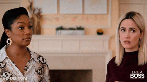 Two Women Standing Next To Each Other With The Words Like A Boss In The Background GIF