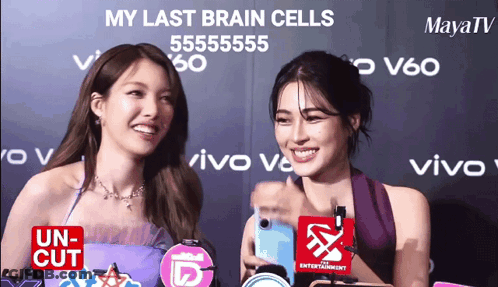 Two Women Standing Next To Each Other With The Words My Last Brain Cells Written On The Wall Behind Them GIF