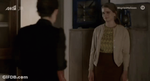 Two Women Standing Saying Agriesmelisses GIF