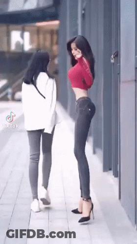 Two Women Standing Side By Side GIF
