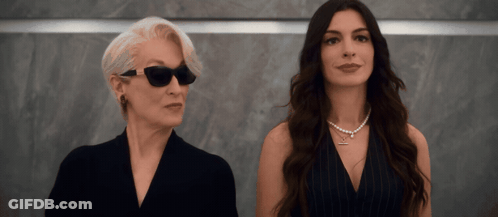 Two Women Standing Together One Wearing Sunglasses GIF
