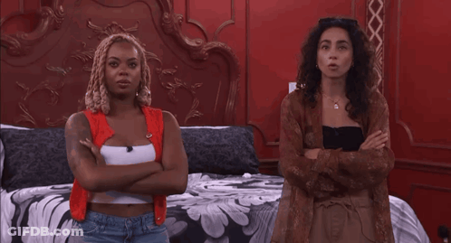 Two Women Standing With Arms Crossed GIF