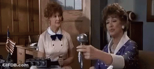 Two Women Standing With Microphone GIF