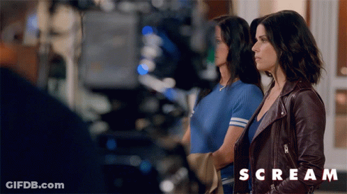 Two Women Standing With Scream Text GIF