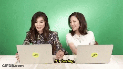 Two Women Talking At Laptops GIF