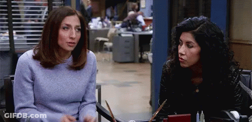 Two Women Talking At Table GIF