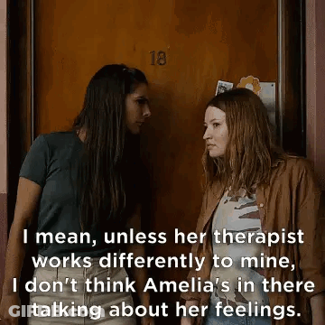 Two Women Talking By Door GIF