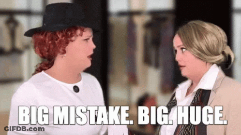 Two Women Talking In A Room One Wearing Top Hat GIF