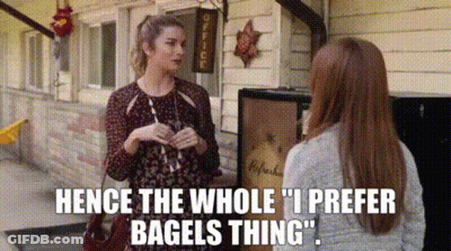 Two Women Talking In Front Of Building GIF
