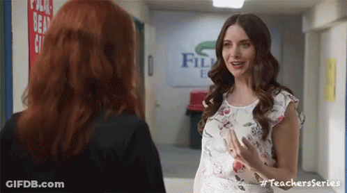 Two Women Talking In Hallway GIF