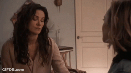 Two Women Talking In Room With Door GIF