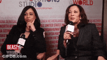 Two Women Talking Into Microphones Beast Women World GIF