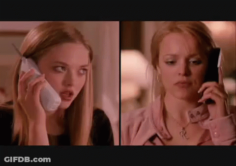 Two Women Talking On Cell Phones GIF