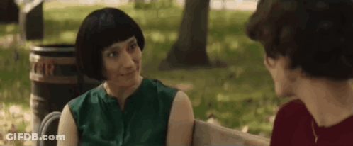 Two Women Talking On Park Bench, One With Wig GIF