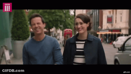 Two Women Talking On Sidewalk GIF