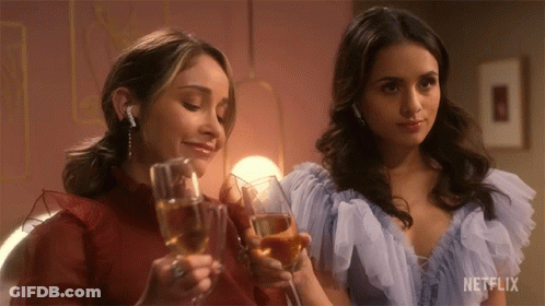Two Women Toasting With Champagne Glasses With A Netflix Logo In The Corner GIF
