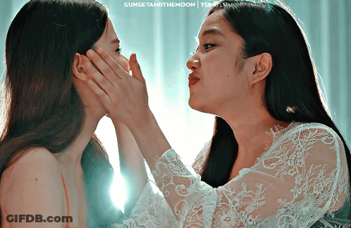 Two Women Touching Faces With Sunset And The Moon GIF