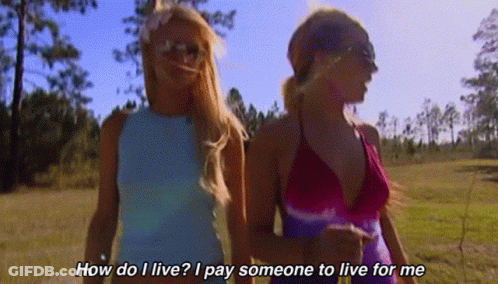 Two Women Walking In A Field With The Words How Do I Live I Pay Someone To Live For Me On The Bottom GIF
