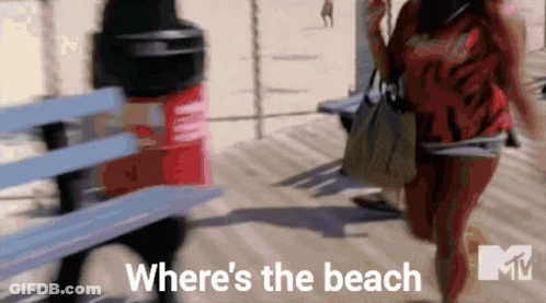 Two Women Walking On A Boardwalk With The Words " Where 'S The Beach " Written On The Bottom GIF