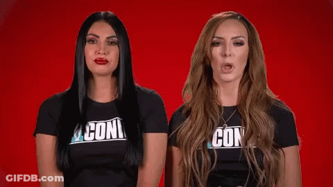 Two Women Wearing Black Shirts With The Word Con On Them GIF
