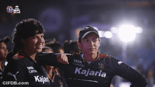 Two Women Wearing Black Shirts With The Word Kajaria On It GIF