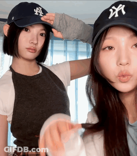 Two Women Wearing NY Hats GIF