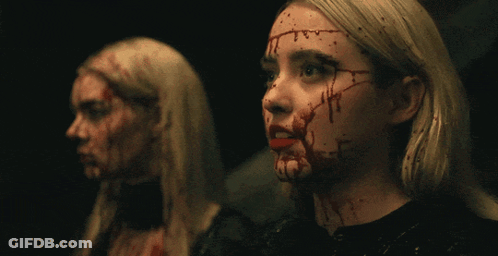 Two Women With Blood On Their Faces Look At Each Other GIF