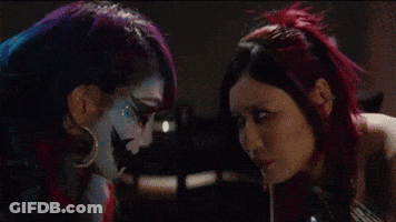 Two Women With Faces Painted Different Colors GIF
