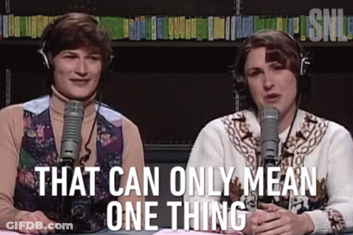 Two Women With Headphones At Microphones With That Can Only Mean One Thing GIF
