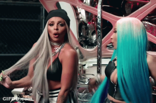 Two Women With Long Hair Are Standing Next To Each Other And One Has A Beanie On GIF